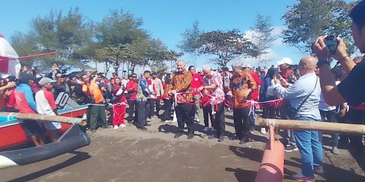 Gubernur Jawa Tengah Ganjar Pranowo bersama GM PLN Unit Induk Distribusi Jawa Tengah dan D.I. Yogyakarta didampingi Direktur Pemasaran dan Pengembangan PLN Enjiniring saat menggunting pita peluncuran kapal bermotor listrik berbasis baterai di Pantai Teluk Penyu, Cilacap. (Wagino/CILACAPMEDIA.com)